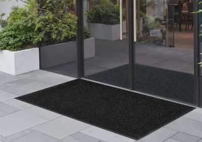Modern anti-slip entrance mat with rubber backing at a stylish UK home entrance