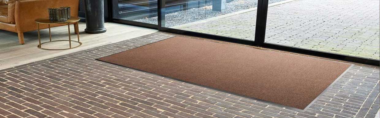 Selection of heavy-duty anti-slip entrance mats in various colours and textures, ideal for UK homes and businesses