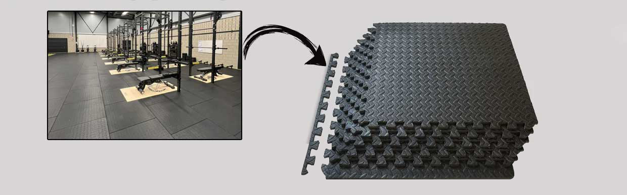 Top view of a modern UK garage gym featuring rubber flooring, dumbbells, and workout bench on interlocking gym tiles