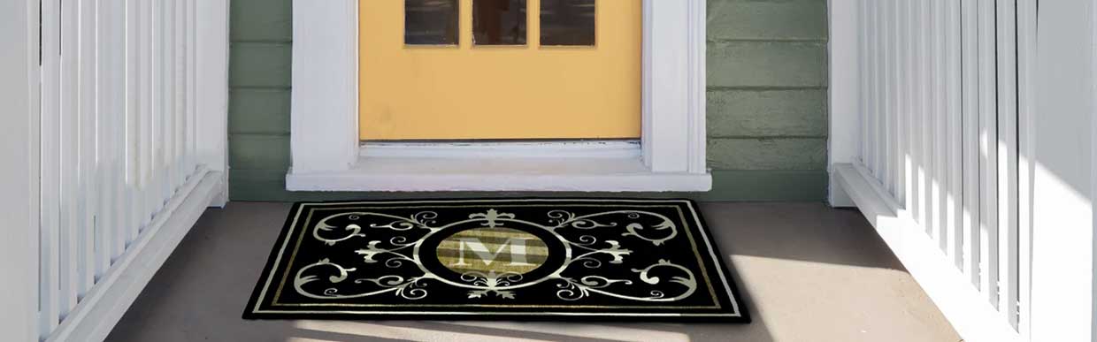 Selection of smart and stylish door mats laid out on a wooden floor, showcasing washable and anti-slip designs for UK homes