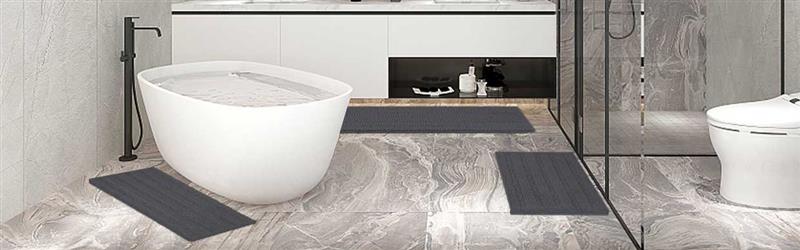 Soft, absorbent cotton bath mat placed in a modern UK bathroom next to a walk-in shower