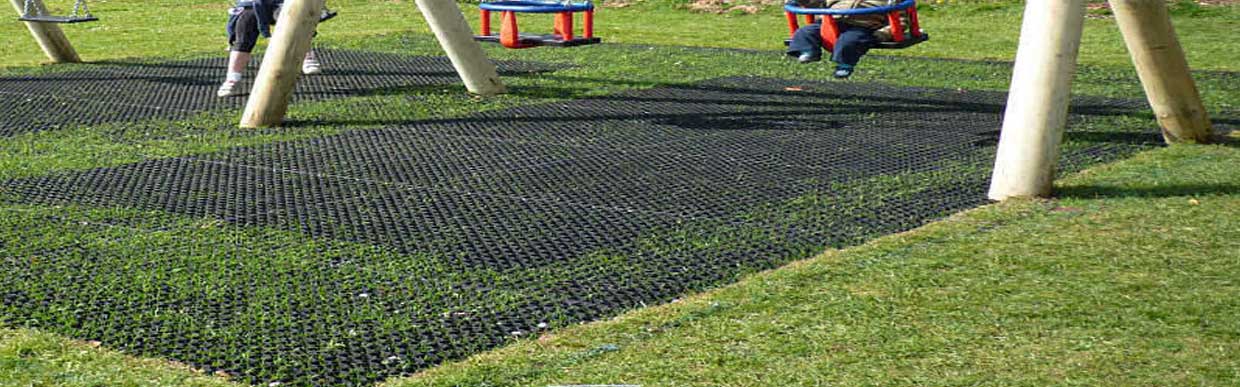 Why Rubber Grass Mats Are the Best Outdoor Flooring for UK Gardens & Play Areas, with a stylized garden, rubber mats, and swing set illustration